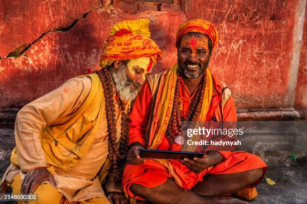 sadhu - indian holymen using digital tablet - kathmandu stock pictures, royalty-free photos & images