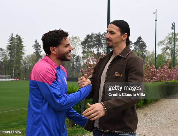 Milan Senior Advisor to Ownership Zlatan Ibrahimovic greets Theo Hernandez of AC Milan during a AC Milan training session at Milanello on April 09,...
