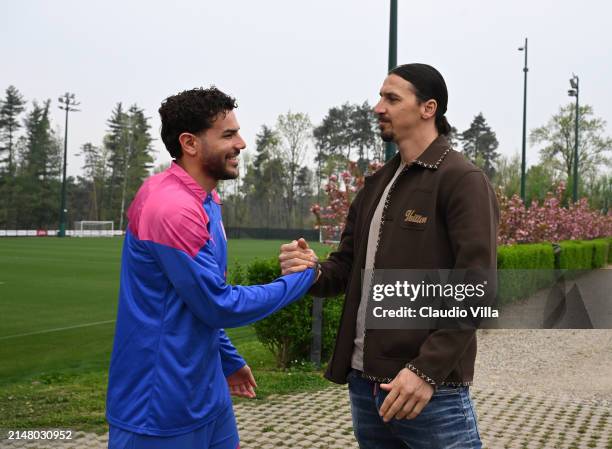 Milan Senior Advisor to Ownership Zlatan Ibrahimovic greets Theo Hernandez of AC Milan during a AC Milan training session at Milanello on April 09,...