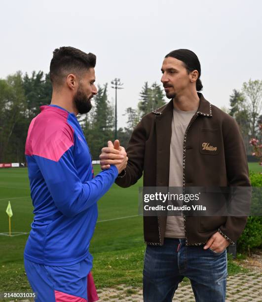 Milan Senior Advisor to Ownership Zlatan Ibrahimovic greets Olivier Giroud of AC Milan during a AC Milan training session at Milanello on April 09,...
