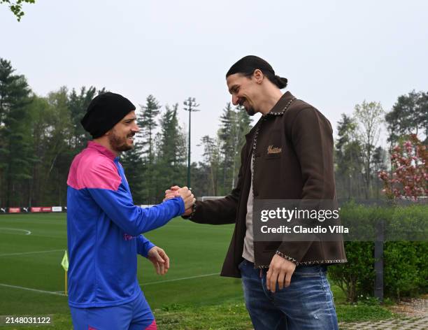Milan Senior Advisor to Ownership Zlatan Ibrahimovic greets Alessandro Florenzi of AC Milan during a AC Milan training session at Milanello on April...