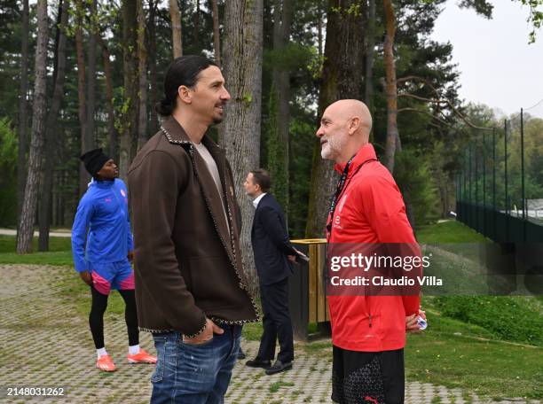 Milan Senior Advisor to Ownership Zlatan Ibrahimovic greets head coach AC Milan Stefano Pioli during a AC Milan training session at Milanello on...
