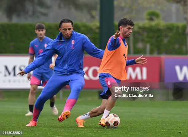 Christian Pulisic and Noah Okafor of AC Milan in action during a AC Milan training session at Milanello on April 09, 2024 in Cairate, Italy.