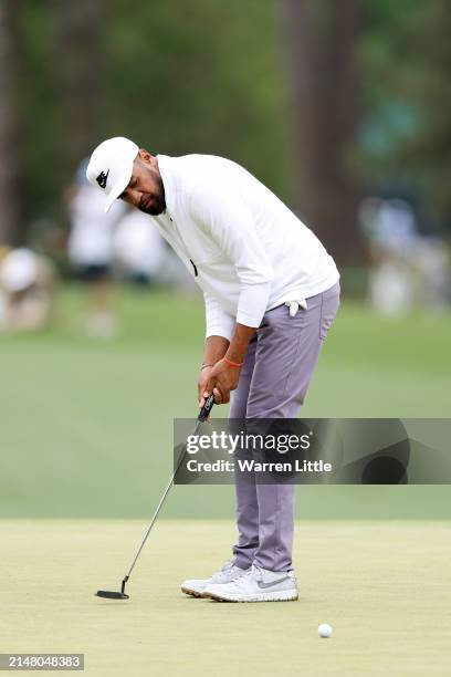 Tony Finau of the United States putts on the third hole during a practice round prior to the 2024 Masters Tournament at Augusta National Golf Club on...