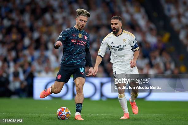 Daniel Carvajal of Real Madrid CF competes for the ball with Jack Grealish of Manchester City during the UEFA Champions League quarter-final first...