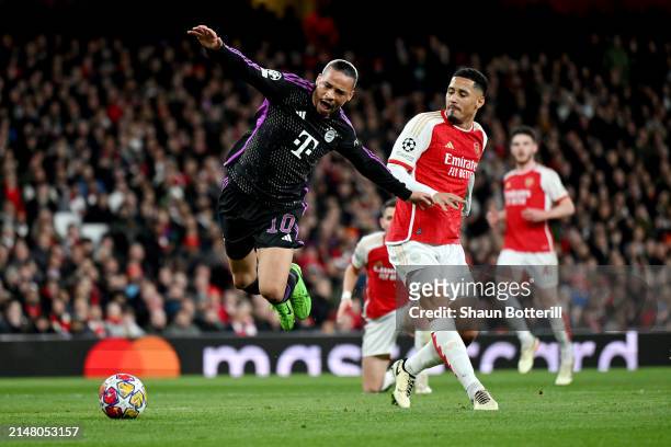 Leroy Sane of Bayern Munich is tackled by William Saliba of Arsenal leading to a penalty decision for Bayern Munich during the UEFA Champions League...