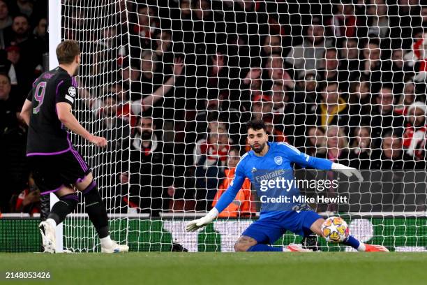 Harry Kane of Bayern Munich scores his team's second goal from the penalty spot as David Raya of Arsenal looks on during the UEFA Champions League...