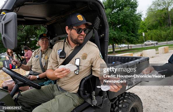 Park Rangers Using Hand Lens City of Austin Parks Rangers hand out eclipse special glasses to ...