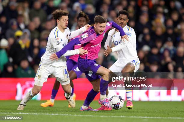 Chris Rigg of Sunderland is challenged by Ethan Ampadu and Junior Firpo of Leeds United during the Sky Bet Championship match between Leeds United...