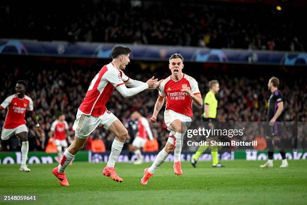 Leandro Trossard of Arsenal celebrates with teammate Kai Havertz after scoring his team's second goal during the UEFA Champions League quarter-final...