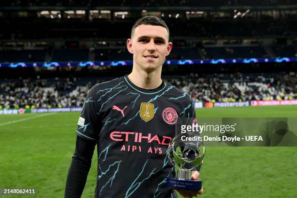 Phil Foden of Manchester City poses for a photo with the PlayStation Player Of The Match award after the draw in the UEFA Champions League...