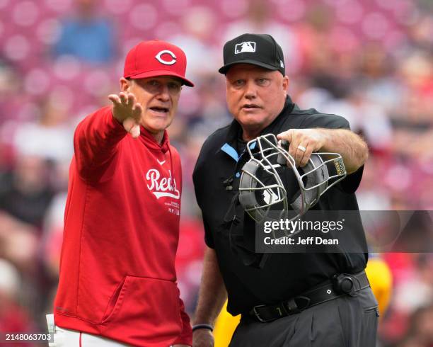 Cincinnati Reds manager David Bell speaks with umpire Brian O'Nora during a baseball game against the Milwaukee Brewers at Great American Ball Park...