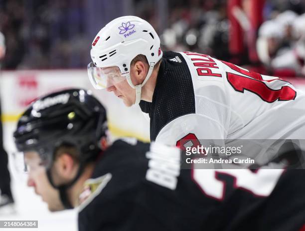 Ondrej Palat of the New Jersey Devils prepares for a face-off against Erik Brannstrom of the Ottawa Senators at Canadian Tire Centre on April 6, 2024...