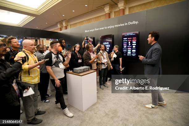 Jed Harmsen from Dolby Laboratories speaks as Michael O’Leary, President & CEO of NATO, leads a guided tour of the Trade Show Floor during CinemaCon,...