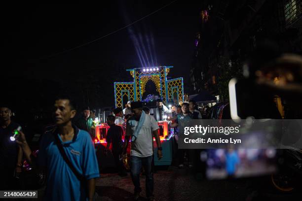 People march alongside a decorated moving platform while chanting takbir ahead of Eid al-Fitr on April 09, 2024 in Selangor, Malaysia. Annually, the...