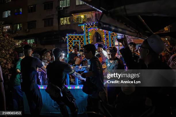 People march alongside a decorated moving platform while chanting takbir ahead of Eid al-Fitr on April 09, 2024 in Selangor, Malaysia. Annually, the...