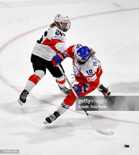 Michaela Pejzlova of Czech Republic gets upended on a tripping penalty by Naemi Herzig of Switzerland in the third period during the 2024 IIHF...