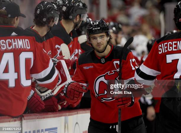 Nico Hischier of the New Jersey Devils celebrates his goal with teammates on the bench during the first period at Prudential Center on April 09, 2024...