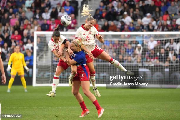 Jessie Fleming and Janine Beckie of Canada collide with Lindsey Horan of the United States at Lower.com Field on April 09, 2024 in Columbus, Ohio.