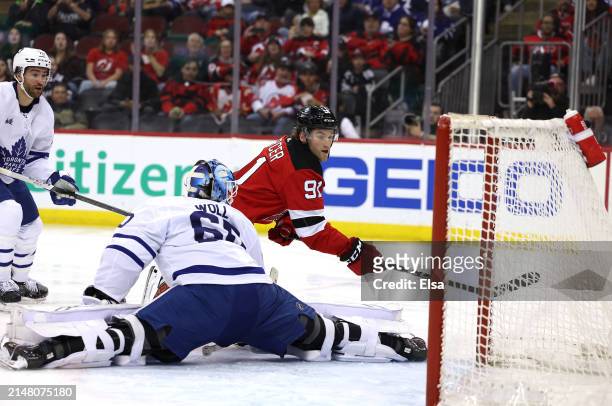 Dawson Mercer of the New Jersey Devils scores during the second period as Joseph Woll of the Toronto Maple Leafs is unable to make the save at...