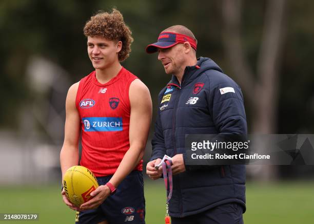 Koltyn Tholstrup of the Demons speaks with Simon Goodwin, Senior Coach of the Demons during a Melbourne Demons AFL training session at Gosch's...