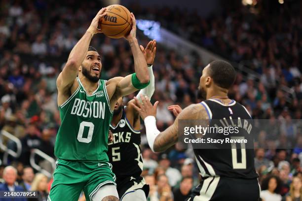 Jayson Tatum of the Boston Celtics drives to the basket against Damian Lillard of the Milwaukee Bucks during the second half of a game at Fiserv...