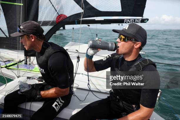 New Zealand's 2024 Paris Olympic Games 49er sailors Isaac McHardie and Will McKenzie refuel as they train out on the water at the Torbay Sailing Club...