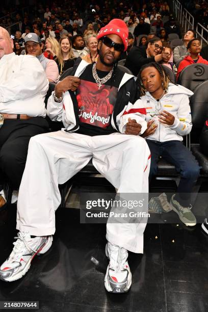 Rapper 2 Chainz and his son Halo Epps attend the game between the Miami Heat and the Atlanta Hawks at State Farm Arena on April 09, 2024 in Atlanta,...