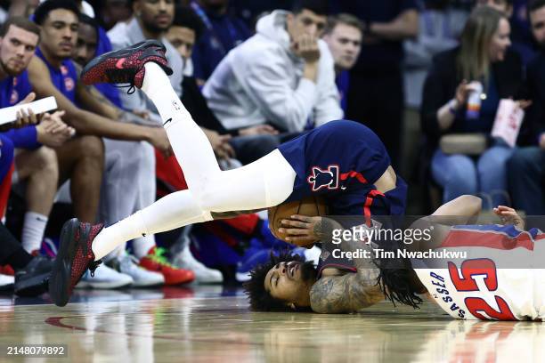 Kelly Oubre Jr. #9 of the Philadelphia 76ers and Marcus Sasser of the Detroit Pistons challenge for the ball during the third quarter at the Wells...