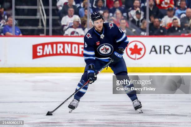 Colin Miller of the Winnipeg Jets plays the puck up the ice during second period action against the Calgary Flames at the Canada Life Centre on April...