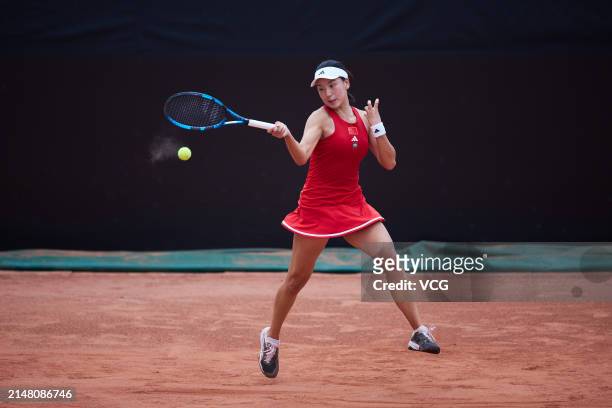 Wang Xinyu of China returns the ball in the Women's Singles match against Joanna Garland of Chinese Taipei during the Billie Jean King Cup 2024...