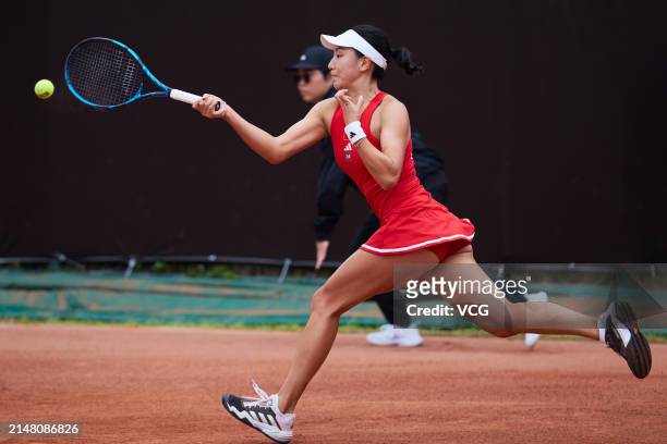 Wang Xinyu of China returns the ball in the Women's Singles match against Joanna Garland of Chinese Taipei during the Billie Jean King Cup 2024...