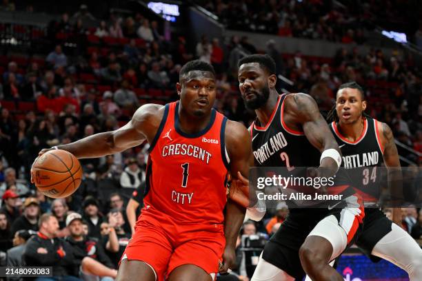 Zion Williamson of the New Orleans Pelicans dribbles against Deandre Ayton of the Portland Trail Blazers during the first quarter of the game at the...
