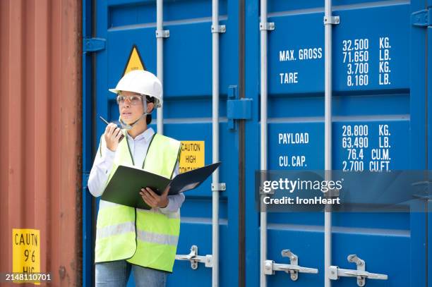 latin woman is working at the container depot. - flammable stock pictures, royalty-free photos & images