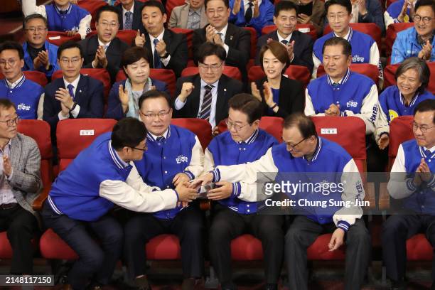 South Korea's main opposition Democratic Party leader Lee Jae-myung and candidates, watches TVs broadcasting the results of exit polls for the...