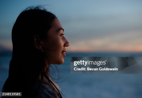 Woman, profile and sunset by ocean with smile, space or thinking with memory for mockup on vacation. Person, girl and happy with ideas in wind by water, beach and sea for tropical holiday in Jakarta Woman, profile and sunset by ocean with smile, space or thinking with memory for mockup on vacation. Person, girl and happy with ideas in wind by water, beach and sea for tropical holiday in Jakarta