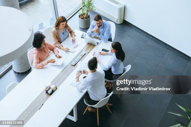 top view of an office meeting in progress - round table discussion women stock pictures, royalty-free photos & images