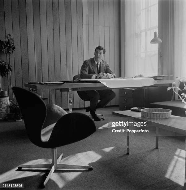 Industrial designer Kenneth Grange seated at a desk in a studio workplace in England in June 1964.