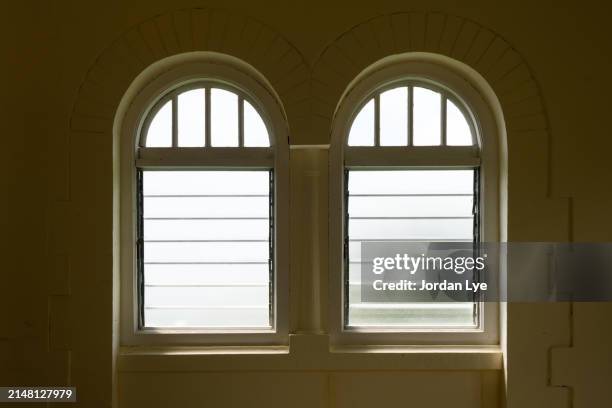 two empty arched windows indoors - stone house interior stock pictures, royalty-free photos & images
