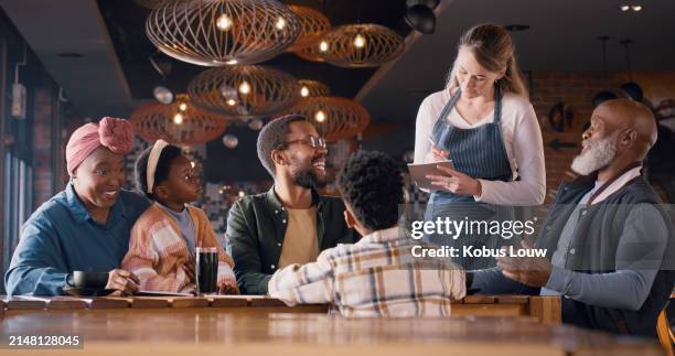 family, restaurant and waitress writing order for customer service, food or lunch information on notebook. happy grandfather, parents and kids with worker for notes and helping with choice at cafe - family ordering at restaurant stock pictures, royalty-free photos & images