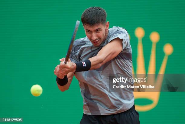 Alexei Popyrin of Australia plays a backhand against Andrey Rublev in their second round match during day four of the Rolex Monte-Carlo Masters at...