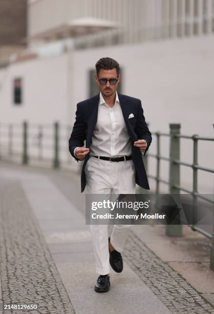 André Hellmundt seen wearing Explicit Poets brown sunglasses with light blue transparent glasses, Olymp white cotton buttoned shirt, Suit Supply...