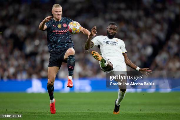 Erling Haaland of Manchester City compete for the ball with Antonio Rudiger of Real Madrid CF during the UEFA Champions League quarter-final first...