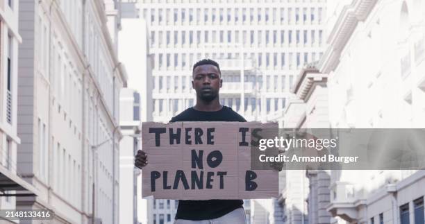 climate change, environment and global warming sign, black man protest and activism in city. earth activist, politics and rally outdoor, poster and environmental strike for planet, global campaign. - environmentalist stock pictures, royalty-free photos & images