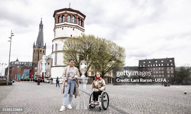 Host city ambassador Selin Oruz and Sandra Mikolaschek pose with the UEFA EURO 2024 trophy during the UEFA Euro 2024 Trophy Tour at Burgplatz on...