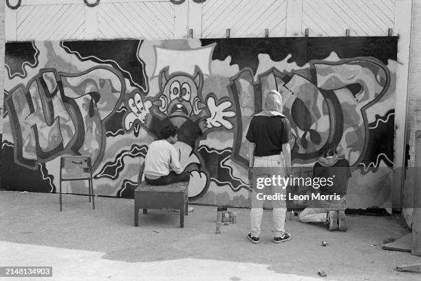 Street artists of graffiti crew The Trailblazers , Zaki Dee 163, Eskimo and Zerox , at work on an artwork made for the GLC Hip Hop Jam, a breakdance...