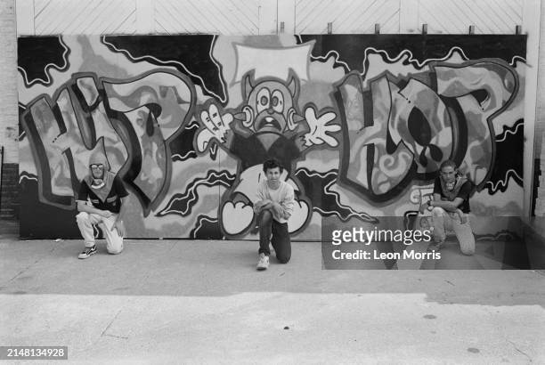 Street artists of graffiti crew The Trailblazers , Zaki Dee 163, Eskimo and Zerox , kneeling in front of their artwork, done in occasion of the GLC...