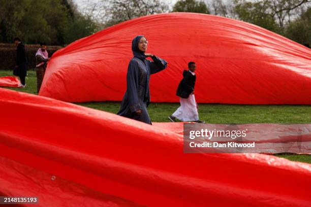 Sheeting used for prayer is packed away after Eid Salah at a 1Eid event in Southall Park on April 10, 2024 in London, England. Eid ul Fitr falls on...