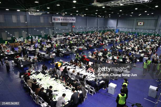 Officials from the South Korean Central Election Management Committee and election observers count votes cast of parliamentary election on April 10,...