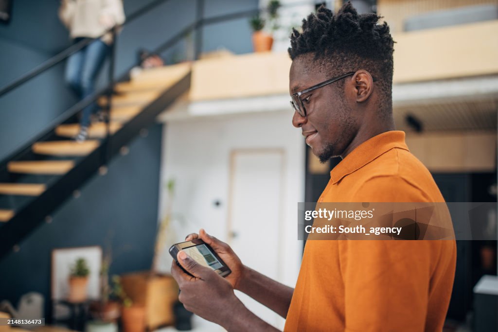 Man Using Devices Man Using Smart Home Control Device High-Res Stock Photo - Getty Images